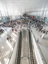 Crowd of people in a busy airport hall getting to their departure gates