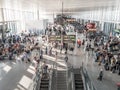 Crowd of people in a busy airport hall getting to their departure gates