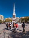 Tourists visiting the memorial obelisk dedicated to General Torrijos in Plaza de la Merced,