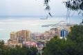 Malaga, Spain, February 2019. Panorama of the Spanish city of Malaga. Buildings, port, bay, ships against a cloudy sky.