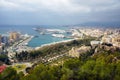 Buildings, port, bay, ships and mountains against a cloudy sky. Dramatic sky over the city. Beautiful view