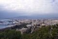 Malaga, Spain, February 2019. Panorama of the Spanish city of Malaga. Buildings, port, bay, ships and mountains against a cloudy s