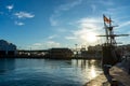 Black sailing yacht on sunset in port in Malaga, Spain on January 14, 2023