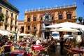 People relaxing at pavement cafes in Obispo Square, Malaga, Spain.