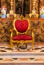 Golden chair with red velvet at the Catedral de Malaga