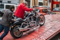 People loading the famous motorcycle on the trailer