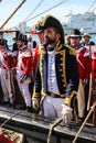 Captain of the 18th century Royal Navy on a ship with his crew. Reenactors