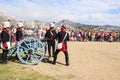 18th century french soldiers loading a cannon with gunpowder. Men and women reenactors.