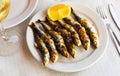 Malaga traditional fried on skewers sardines on plate on wooden table