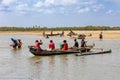 Malagasy family in traditional wooden boat crossing River in Morondava, Madagascar. Royalty Free Stock Photo