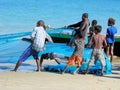 Malagasy fishermen get fishing nets from the sea