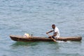 Malagasy man on sea in traditional handmade dugout wooden boat