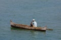 Malagasy man on sea in traditional handmade dugout wooden boat