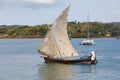 Malagasy man on sea in traditional handmade dugout wooden sailing boat