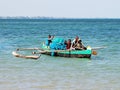 Malagasy fishing canoe on the see with fishermen