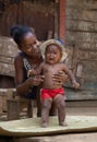 Malagasy woman with baby resting in shadow, Madagascar