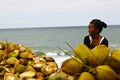 Malagasy woman selling coconuts on the beach