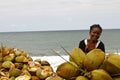 Malagasy woman selling coconuts on the beach