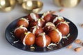 Malai Gulab Jamun. Gulab Jamun sandwich with milk cream filling. Fusion of Indian sweet dessert, golden brown, soft, and soaked in Royalty Free Stock Photo