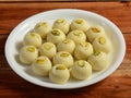 Malai peda a sweet dish from india made from milk and khoya means milk solid or mava. served over a white plate on a rustic wooden