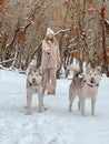 Owner with two malamute dogs walking on the snow Royalty Free Stock Photo