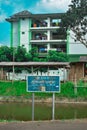 A sign that reads prohibited from throwing garbage in the river in Indonesian in front of flats in Malang city