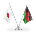 Malawi and Japan table flags isolated on white 3D rendering