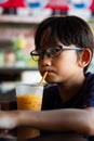 Malay asian child drinking at a hawker local style restaurant