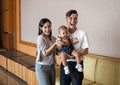 Malay Asian Young Couple with One Year Old Child Daughter, brown background