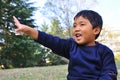 A Malay child with a hand raised up