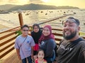 Malay Muslim family taking self portrait photo while traveling on vacation at the beach in Malaysia Royalty Free Stock Photo