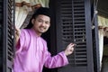 Malay muslim man open a traditional window Royalty Free Stock Photo
