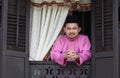 Malay muslim man open a traditional window Royalty Free Stock Photo