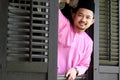 Malay muslim man open a traditional window Royalty Free Stock Photo