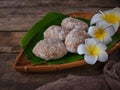 A Malay traditional dessert called Getas on bamboo dustpan over wooden background. Royalty Free Stock Photo