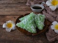 A Malay traditional dessert called Kuih Lopes on plate with flower and cloth decoration over wooden background Royalty Free Stock Photo