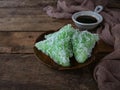 A Malay traditional dessert called Kuih Lopes on plate over wooden background. Royalty Free Stock Photo