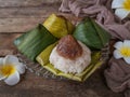 A Malay traditional dessert called Kuih Lopes on plate with flower and cloth decoration over wooden background Royalty Free Stock Photo