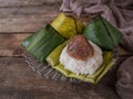 A Malay traditional dessert called Pulut Manis on plate over wooden background. Royalty Free Stock Photo