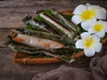 A Malay traditional dessert called Pulut Panggang on bamboo dustpan over wooden background. Royalty Free Stock Photo