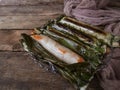 A Malay traditional dessert called Pulut Panggang on plate over wooden background. Royalty Free Stock Photo