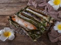 A Malay traditional dessert called Pulut Panggang on plate with flower and cloth decoration over wooden background Royalty Free Stock Photo