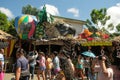 Malaybalay City, Philippines - people walk on busy street with decorated nipa huts as pop-up stores at the Kaamulan Festival.