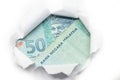Malaysia currency peeking through white paper
