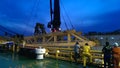 Crew working on riser guard to install at pipeline platform in east coast Malaysia during night.