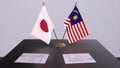 Malaysia and Japan national flags, political deal, diplomatic meeting. Politics and business 3D illustration