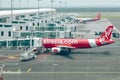 Passengers using jet bridge to boarding in airplane by Airasia airline.