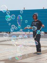 Malaysian young girl makes big bubbles in a Kuching public outdoor place Royalty Free Stock Photo