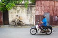 MALAYSIA, PENANG, GEORGETOWN - CIRCA JUL 2014: Real bicycle juxtaposed over lifesize mural of children riding a bicycle.