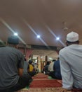 People listening to the Friday sermon at a mosque.
